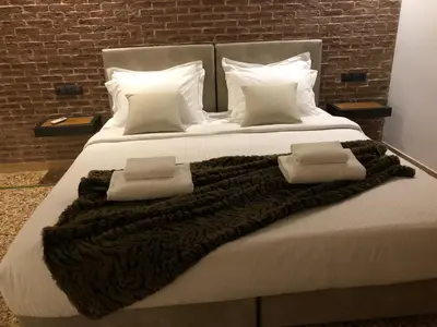 a large bed with two pillows and a blanket at Athens Oasis in Athens