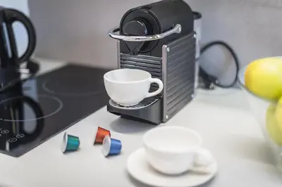 a toaster oven with a cup on top of it at Athens Oasis in Athens