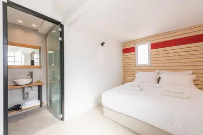 a bedroom with a large white bed and a mirror at Athens Oasis in Athens