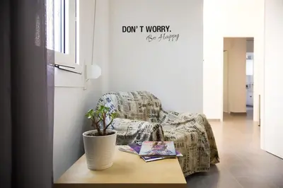 a living room with a chair and a table with a plant at Top GroundFloor in Mets in Athens