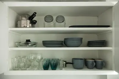 a white cabinet filled with plates and glasses at Top GroundFloor in Mets in Athens