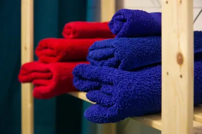 a pile of towels sitting on a shelf at Top GroundFloor in Mets in Athens