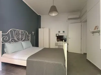 a bedroom with a bed and a refrigerator at Top GroundFloor in Mets in Athens