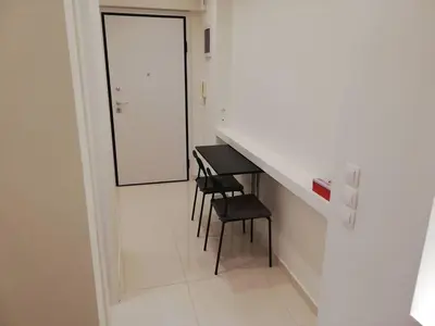a room with a counter and a stool and a table at White Lux Apartment For 2 VIPGreece in Athens