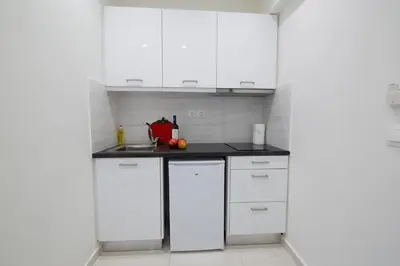 a white kitchen with white cabinets and a sink at White Lux Apartment For 2 VIPGreece in Athens