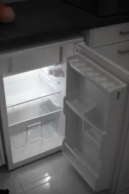 an empty refrigerator with its door open in a kitchen at White Lux Apartment For 2 VIPGreece in Athens