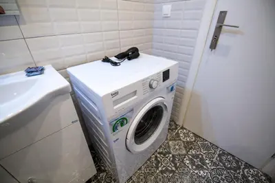 a washing machine in a bathroom next to a sink at White Lux Apartment For 2 VIPGreece in Athens