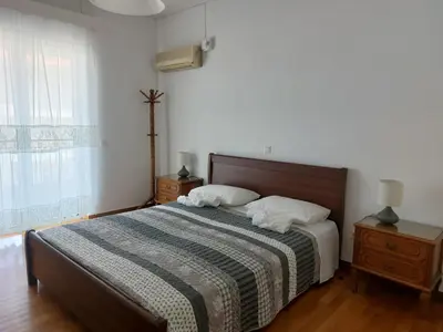 a bedroom with a bed with two pillows on it at Sea view,big and comfortable appartment in Voula in Athens