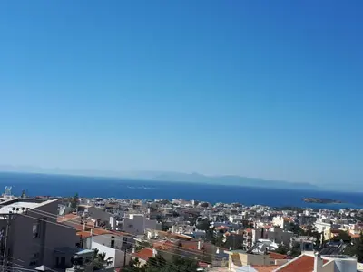 a city with the ocean in the background at Sea view,big and comfortable appartment in Voula in Athens