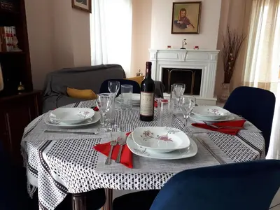 a table with a bottle of wine and plates and glasses at Sea view,big and comfortable appartment in Voula in Athens