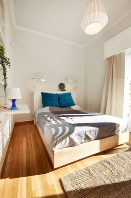 a bedroom with a large bed with blue pillows at Chloe Boutique Apartments Metropolis in Athens