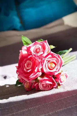 a bouquet of pink roses sitting on a table at Chloe Boutique Apartments Metropolis in Athens