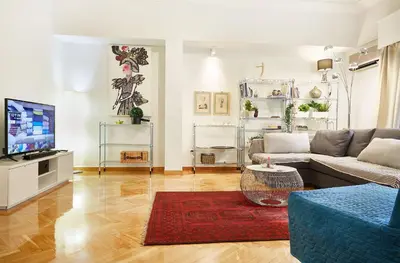a living room with a couch and a tv at Chloe Boutique Apartments Metropolis in Athens