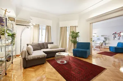 a living room with a couch and a table at Chloe Boutique Apartments Metropolis in Athens