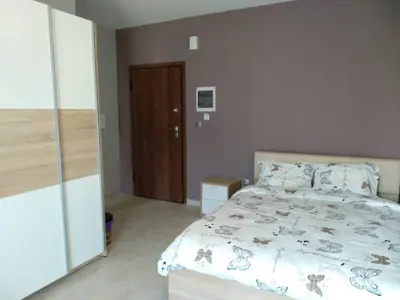 a bedroom with a bed and a wooden door at Paidon Studio in Athens