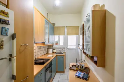 a small kitchen with blue cabinets and a sink at Sophie's Penthouse in Athens in Athens
