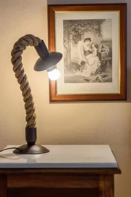 a lamp sitting on top of a table with a picture at Sophie's Penthouse in Athens in Athens