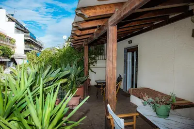 a patio with plants and a table on a building at Sophie's Penthouse in Athens in Athens