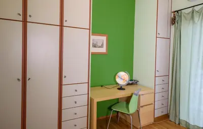 a room with a desk and a green wall at Sophie's Penthouse in Athens in Athens