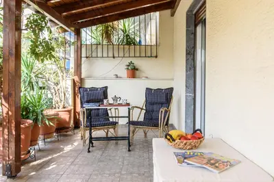 a patio with chairs and a table with a basket of fruit at Sophie's Penthouse in Athens in Athens