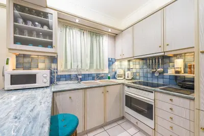 a kitchen with a sink and a microwave at Amazing Apartment Pallini - Near Airport & Metro in Pallíni