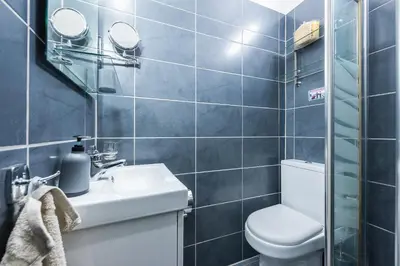 a bathroom with a toilet and a sink at Amazing Apartment Pallini - Near Airport & Metro in Pallíni