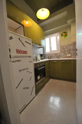 a kitchen with a refrigerator in a room at Cosy appartment in the heart of Athens in Athens