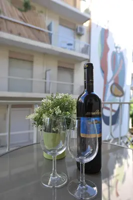 a bottle of wine and two glasses on a table at Cosy appartment in the heart of Athens in Athens