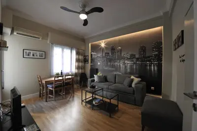 a living room with a couch and a table at Cosy appartment in the heart of Athens in Athens