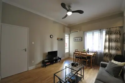 a living room with a couch and a table at Cosy appartment in the heart of Athens in Athens
