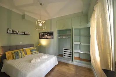 a bedroom with a bed and a walk in closet at Cosy appartment in the heart of Athens in Athens