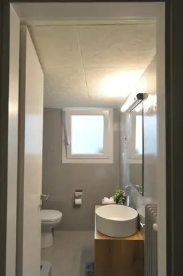 a bathroom with a sink and a toilet and a window at Cosy appartment in the heart of Athens in Athens