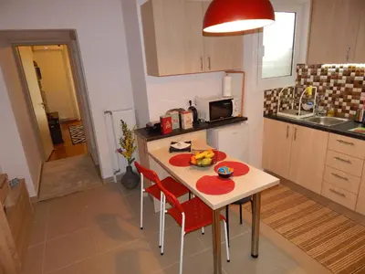 a kitchen with a table with a bowl of fruit on it at ANNA in Athens