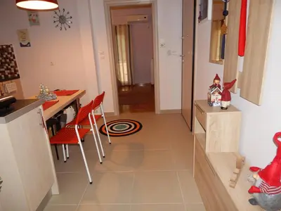 a kitchen with a table and a desk with red chairs at ANNA in Athens