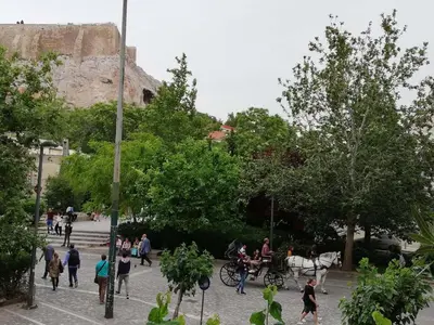 a group of people walking around in a park at Parthenon View Apt in Athens