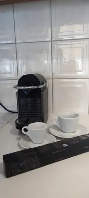 a counter with two cups and a microwave at Parthenon View Apt in Athens
