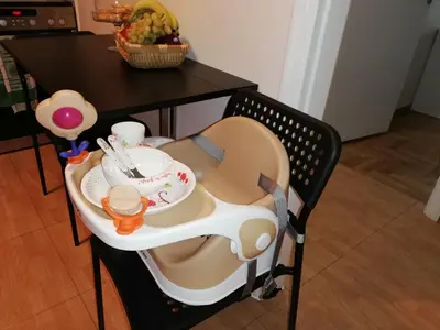 a childs high chair with a table and a tableablish at Parthenon View Apt in Athens