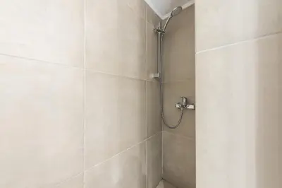 a bathroom with a shower with a shower head at Athens Centre Flat 2 min. from Evangelismos Metro in Athens