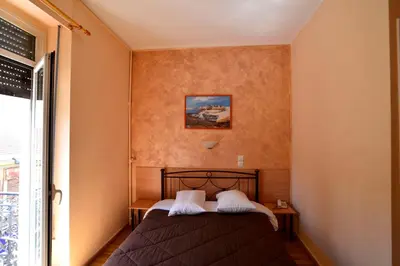 a bedroom with a bed and a painting on the wall at Electra Hotel Piraeus in Piraeus