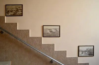 a staircase with three pictures on the wall at Electra Hotel Piraeus in Piraeus