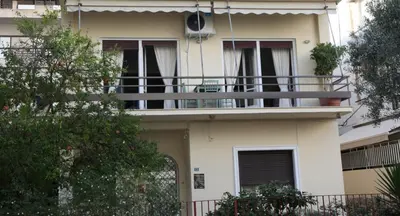 a white house with a balcony and trees at Stylish Flat at Edem Beach by Athenian Homes in Athens
