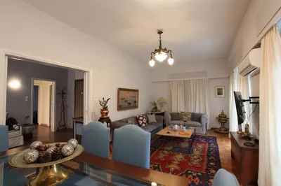 a living room with a couch and a table at Stylish Flat at Edem Beach by Athenian Homes in Athens