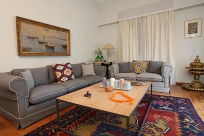 a living room with a couch and a table at Stylish Flat at Edem Beach by Athenian Homes in Athens
