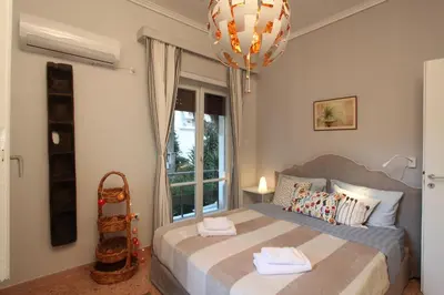 a bedroom with a bed with two towels on it at Stylish Flat at Edem Beach by Athenian Homes in Athens