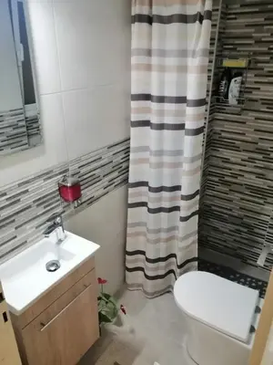a bathroom with a toilet and a shower curtain at Alexandras Metro Studio&200mbps in Athens