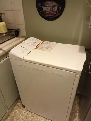 a white refrigerator sitting in a kitchen next to a counter at Alexandras Metro Studio&200mbps in Athens