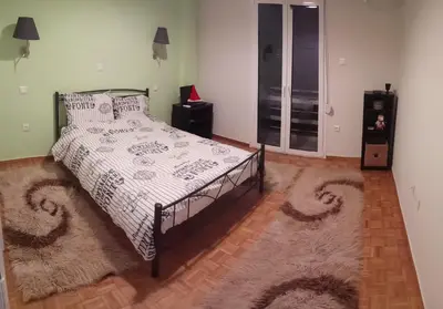 a bedroom with a bed with a white comforter and a rug at MyHome! Modern, huge, central, quiet, clean in Athens