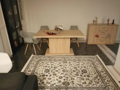 a table and chairs in a room with a rug at MyHome! Modern, huge, central, quiet, clean in Athens