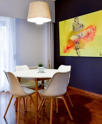 a dining room with a white table and chairs at 20 times Athens in Athens