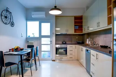 a kitchen with a table and chairs and a dining room at 20 times Athens in Athens